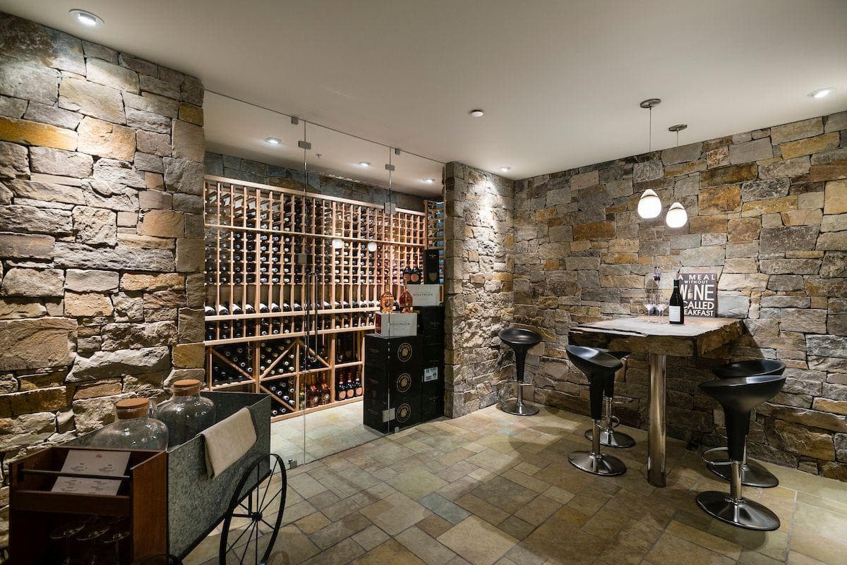 Wine cellar with climate-controlled glass storage and high-top seating for 4