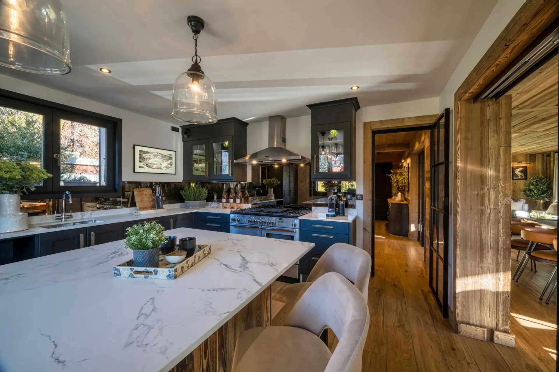 Kitchen with a marble island and mirrored splashbacks