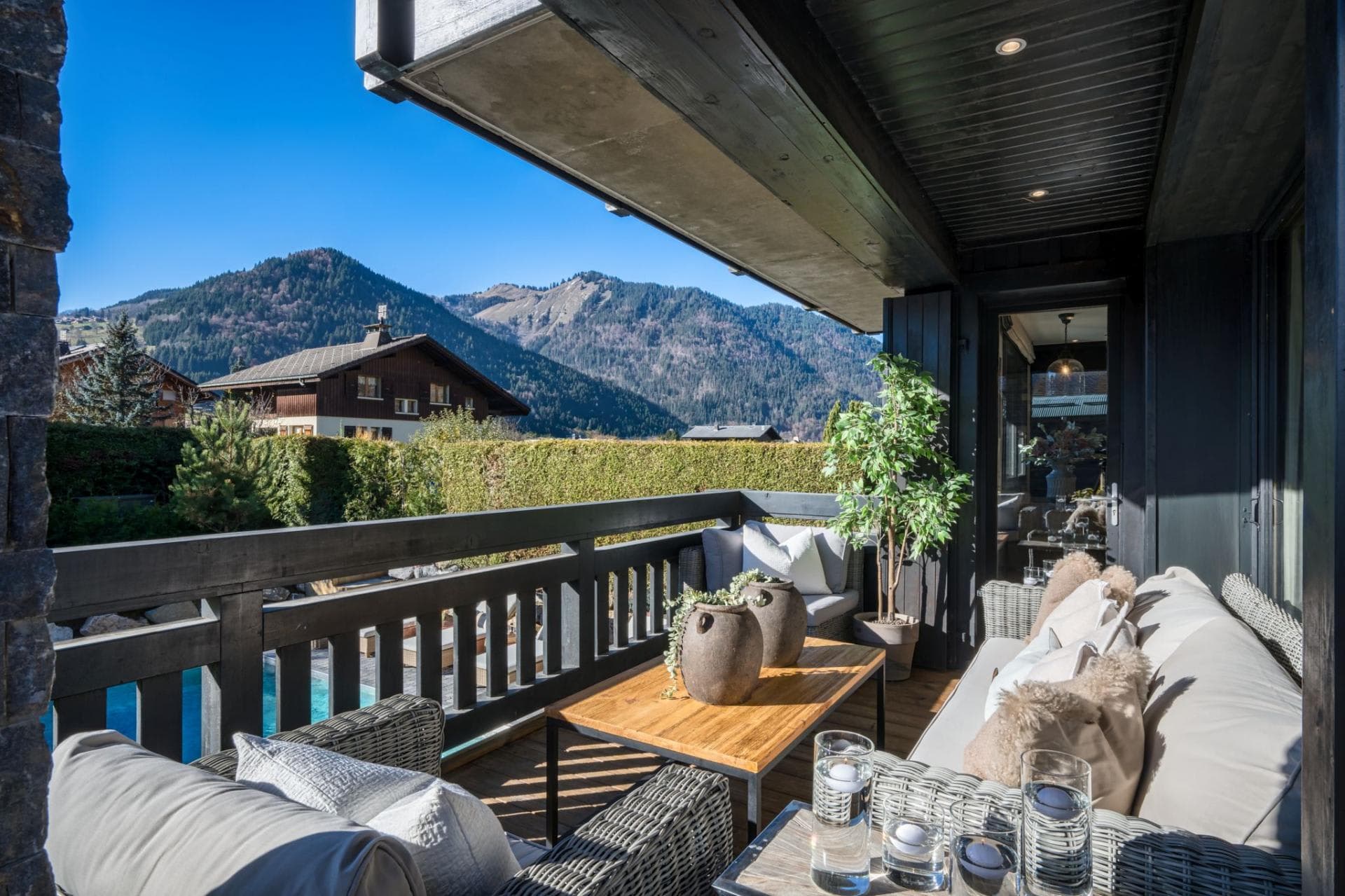 Covered balcony with lounge seating and mountain valley views