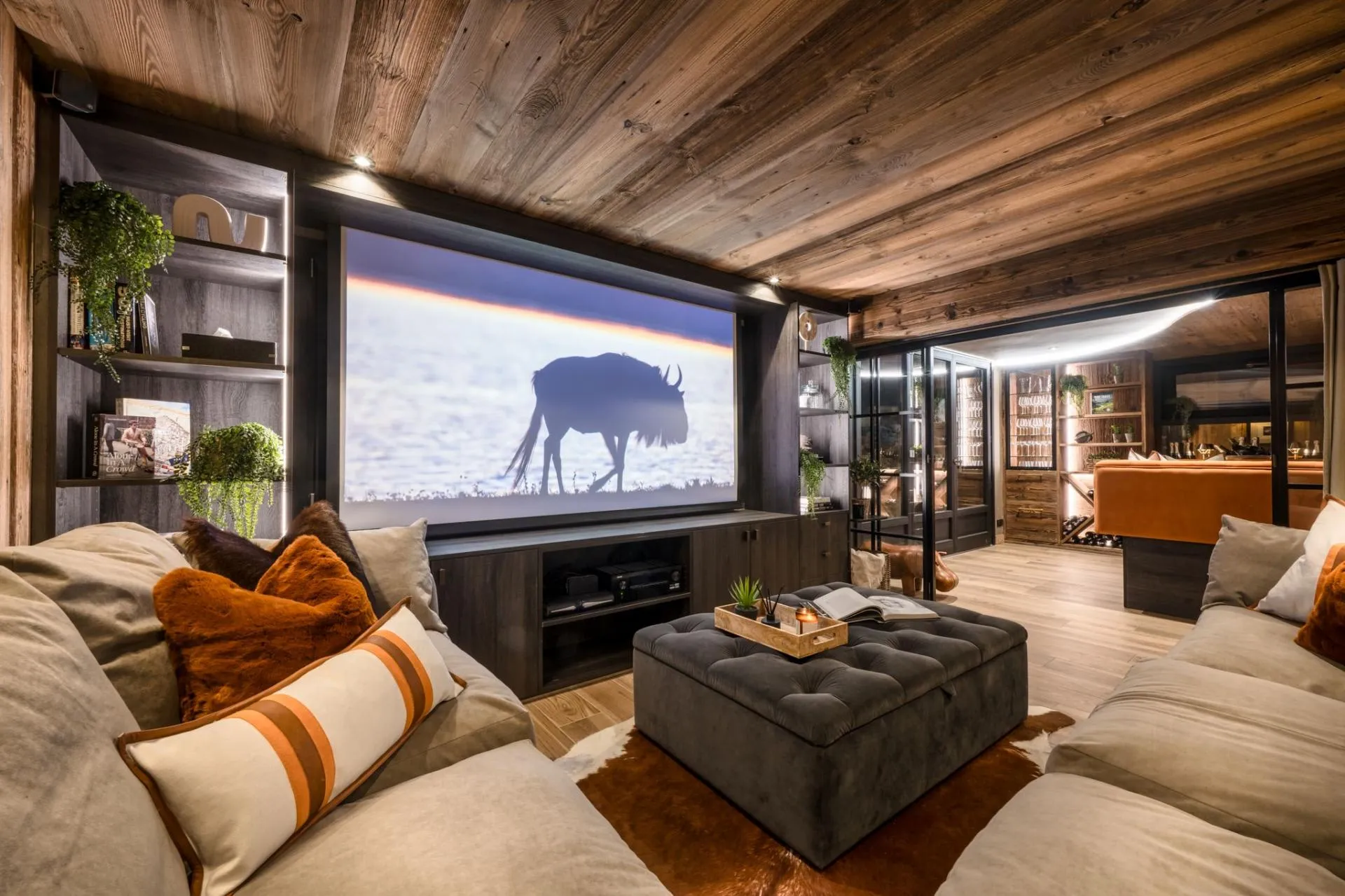 Home cinema room with projector screen and curtained glass doors