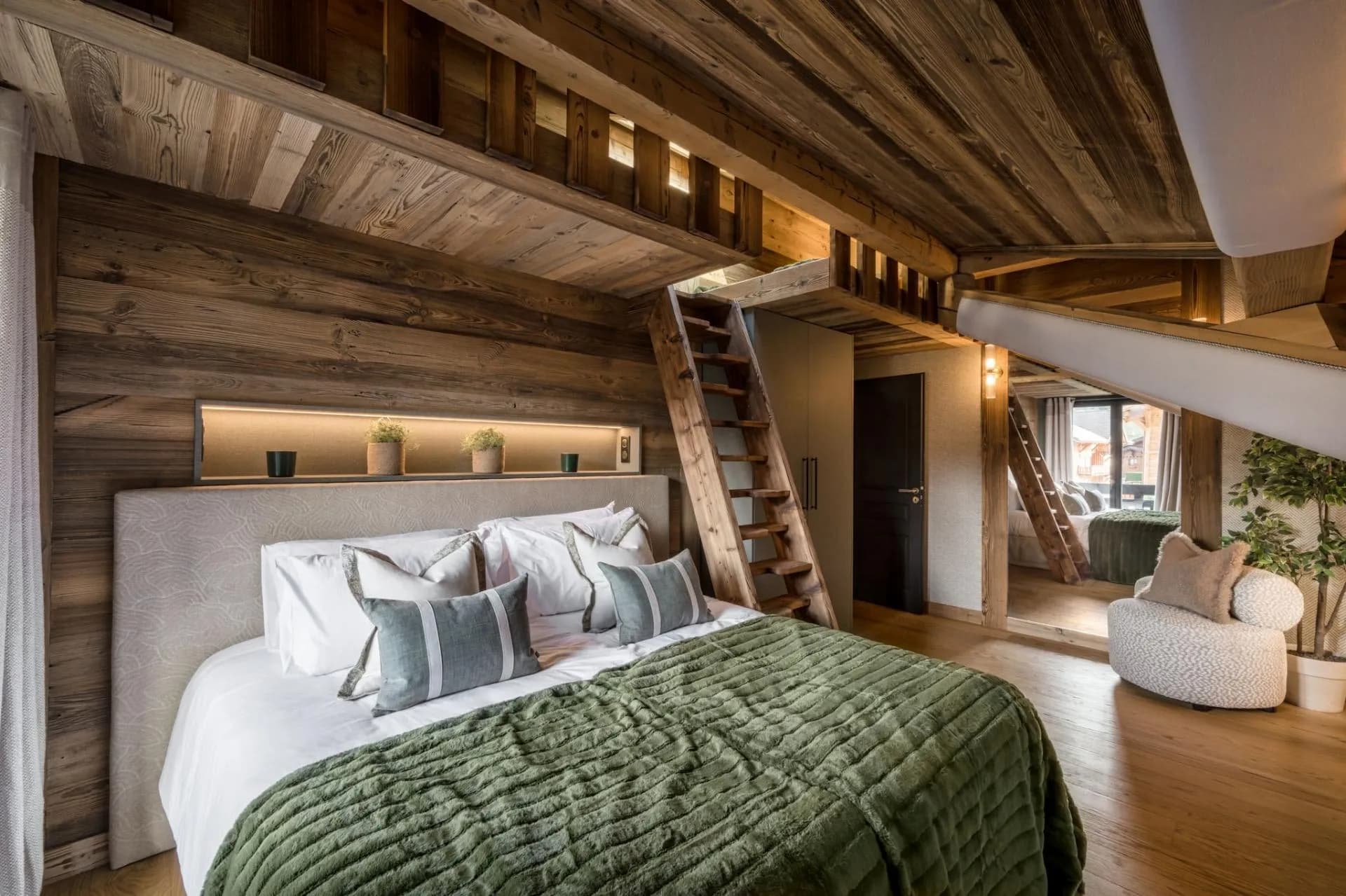 King-or-twin bedroom with ladder access to two raised bunk beds
