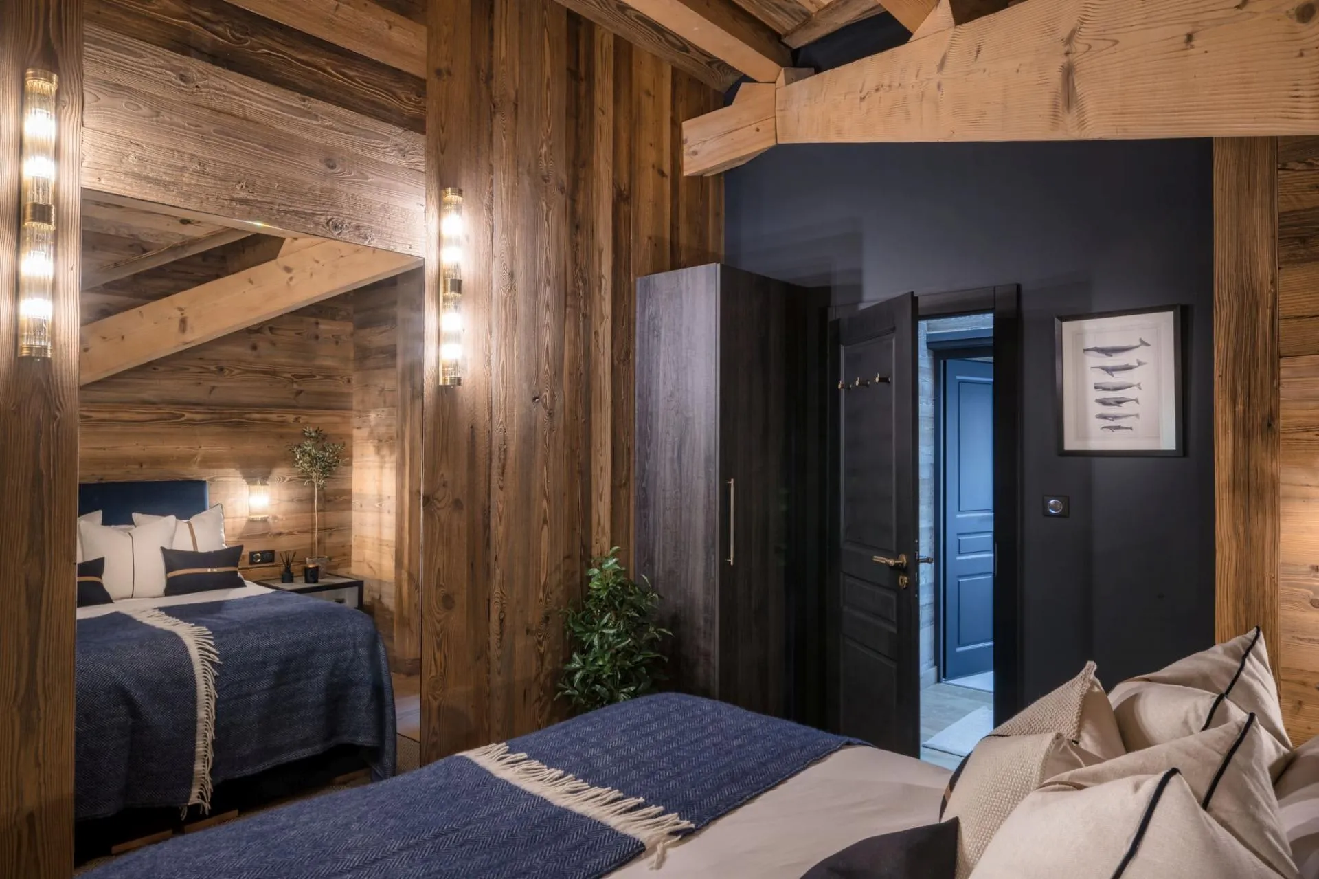 King-or-twin bedroom with a vaulted timber ceiling and full-height mirror