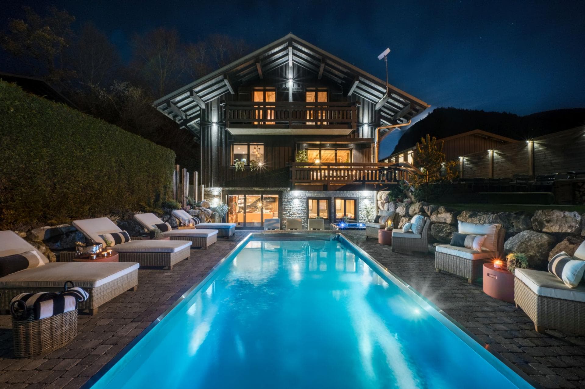 Heated outdoor swimming pool and chalet terrace after dark
