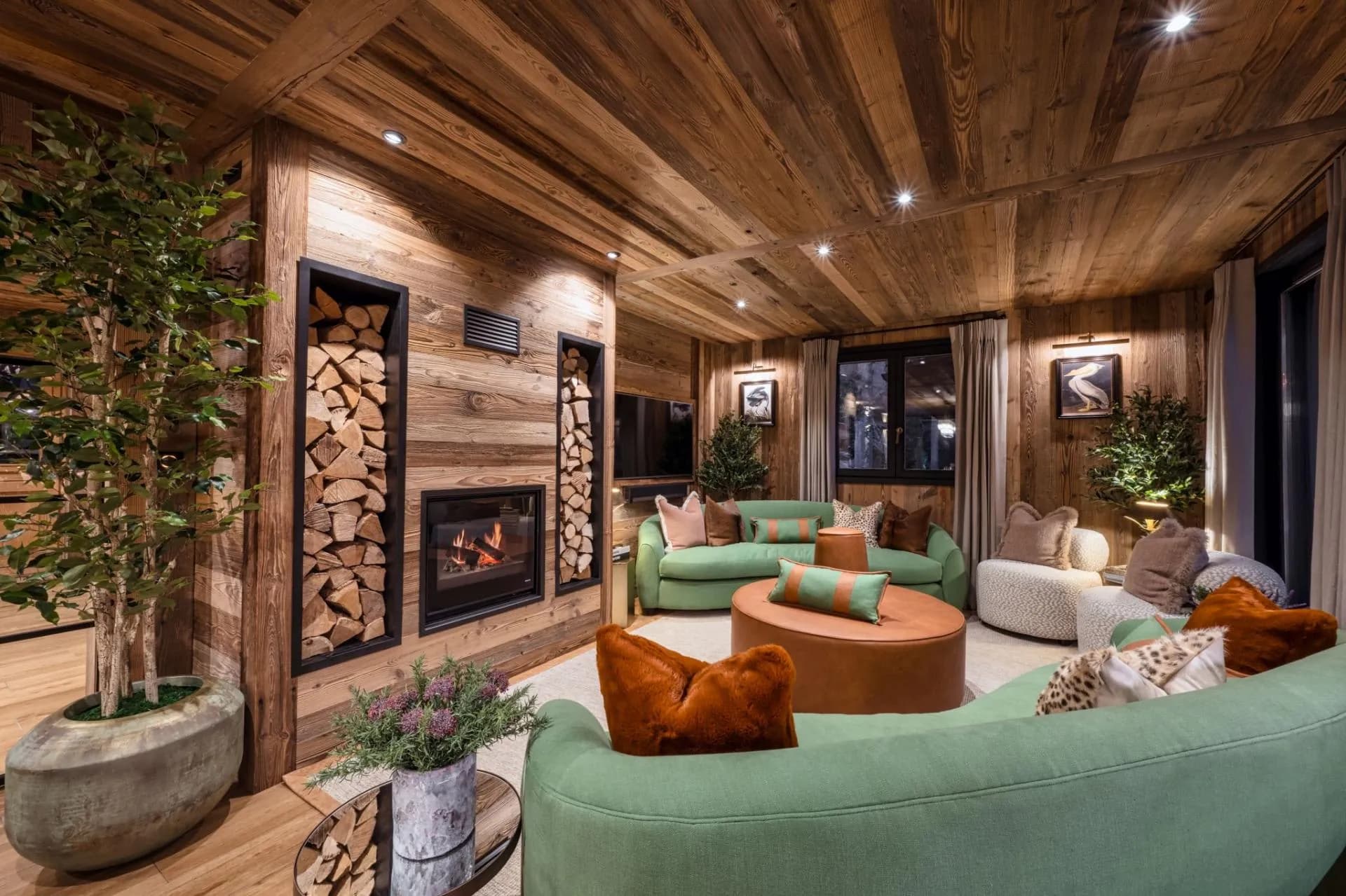 Living area with a feature fireplace and built-in firewood storage