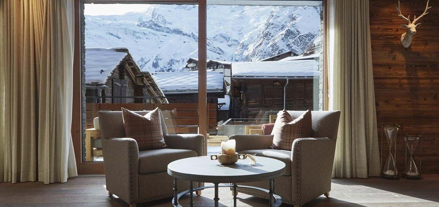 Seating area with mountain views through floor-to-ceiling windows