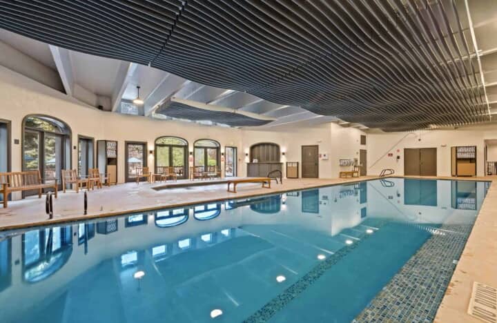 Indoor pool with hot tub and outdoor patio access