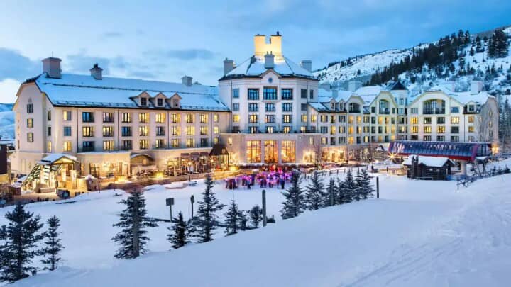 Mountain resort exterior with ski-in/ski-out access and evening courtyard