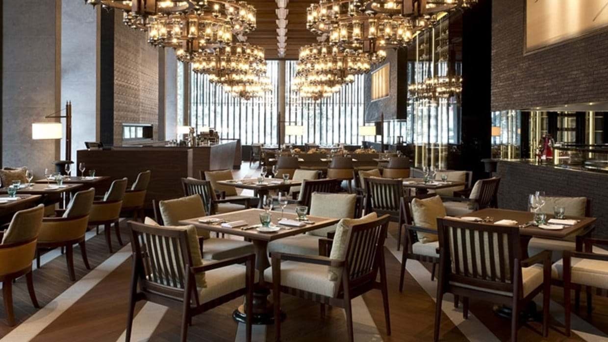 On-site dining room with table seating and integrated wine cellar display