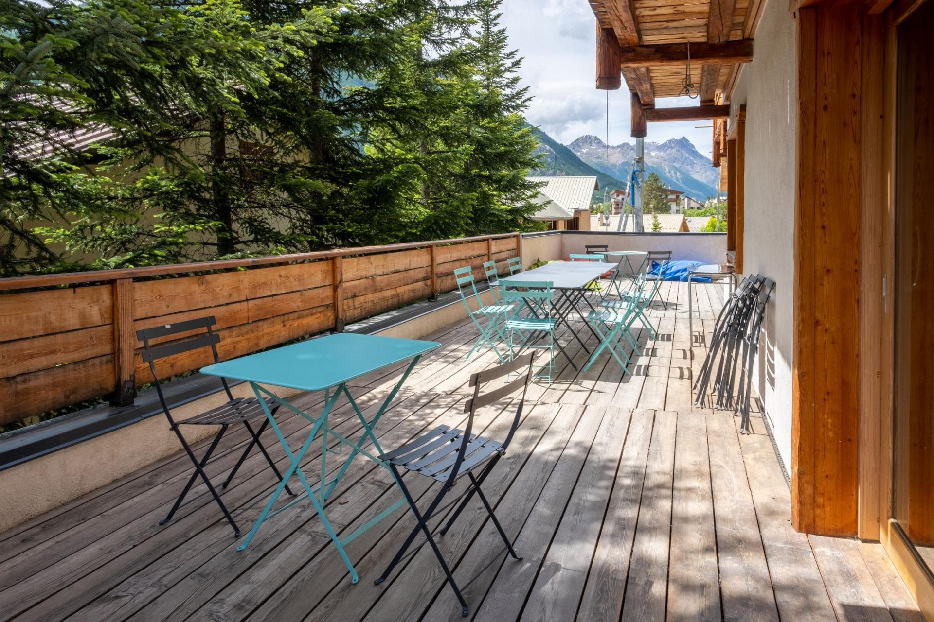 Wood-decked balcony with bistro seating for 10 and mountain views