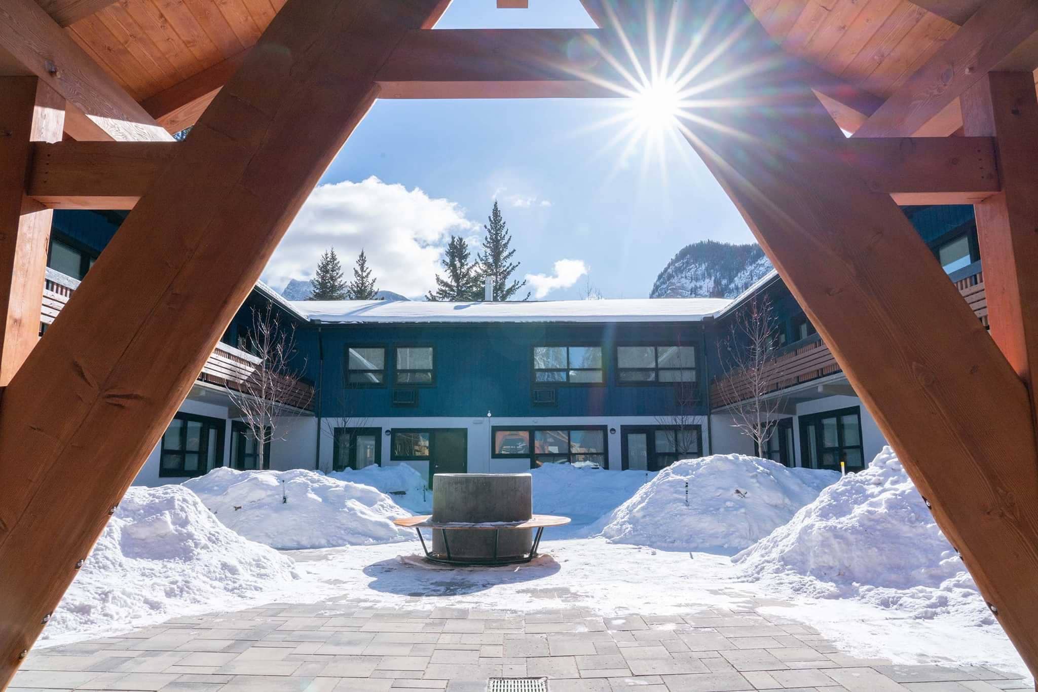 Inner courtyard with circular fire pit and views of mountain peaks