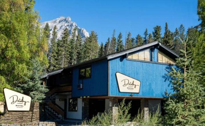 Two-story motel exterior with mountain views and wood siding