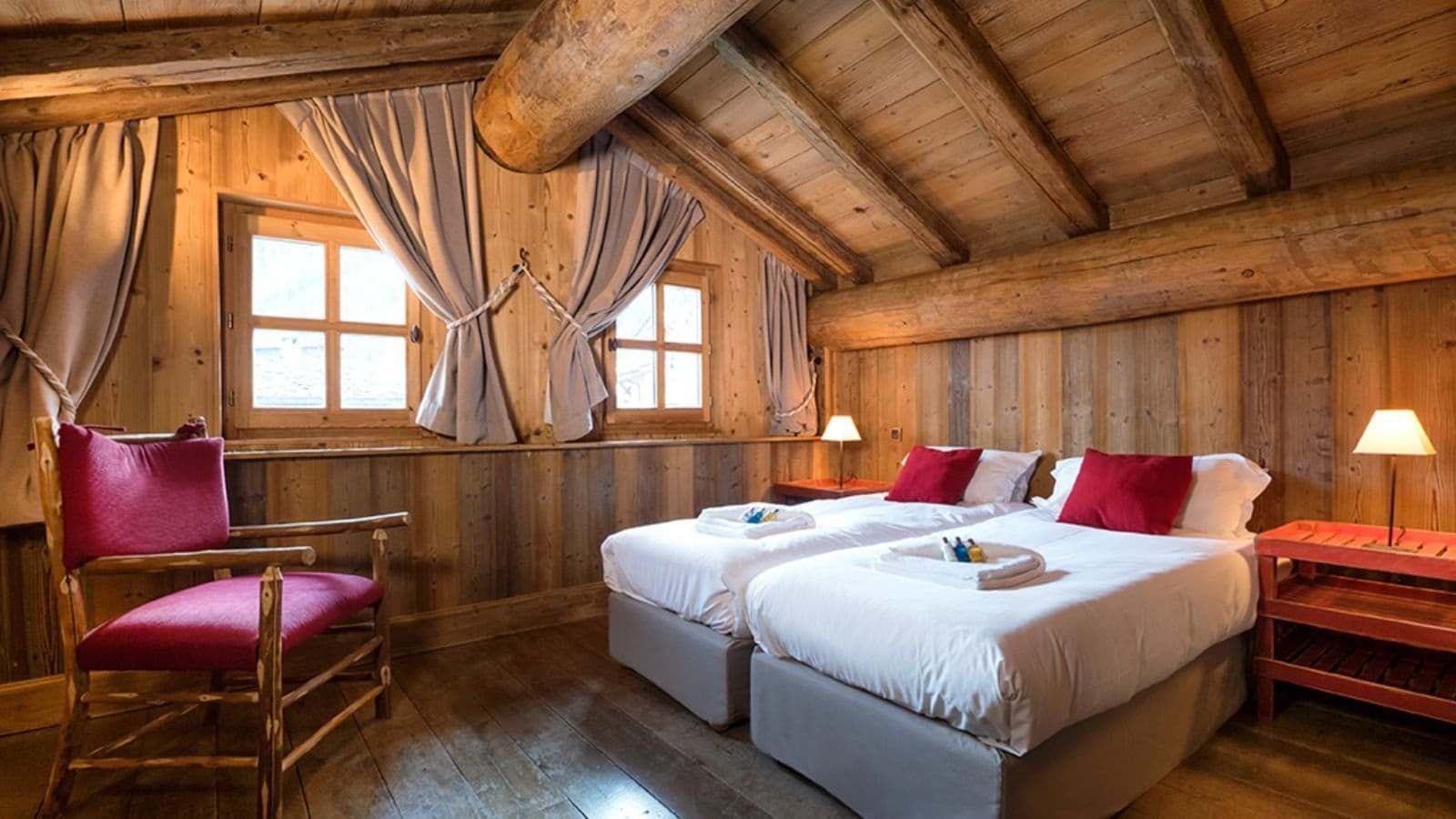 Bedroom with twin beds and exposed log beams