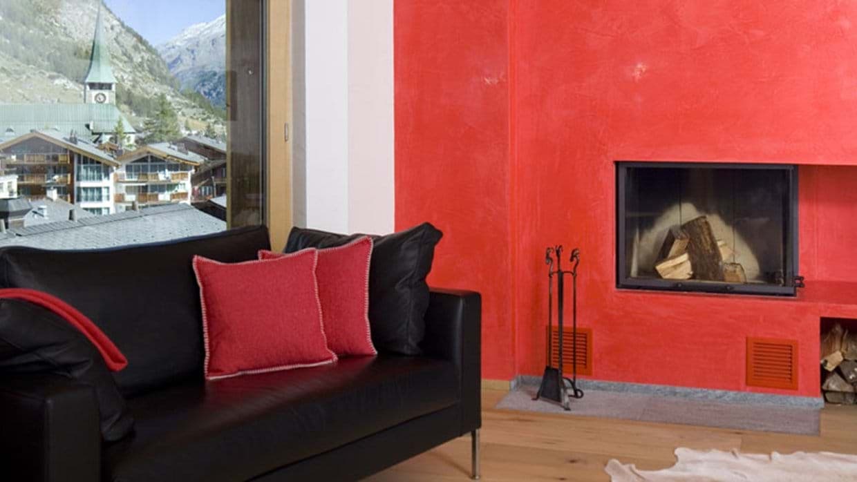 Living area with wood-burning fireplace and village views