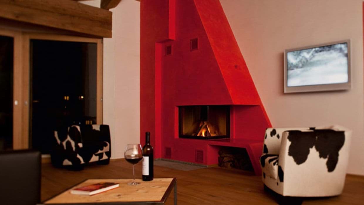 Living area with wood-burning fireplace and wall-mounted TV