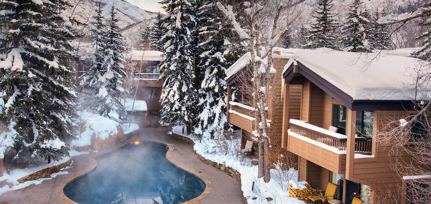 Heated year-round pool; private balconies overlooking snowy mountain landscape