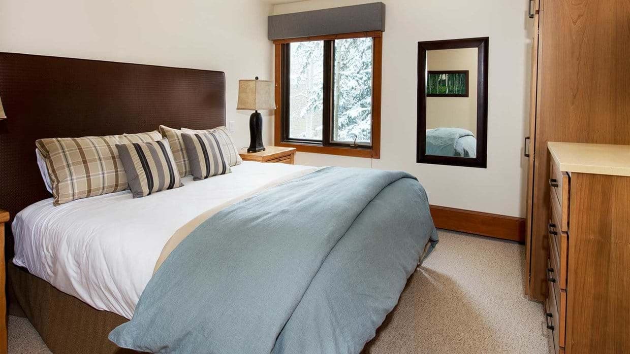 Bedroom with king bed and window view of snowy trees