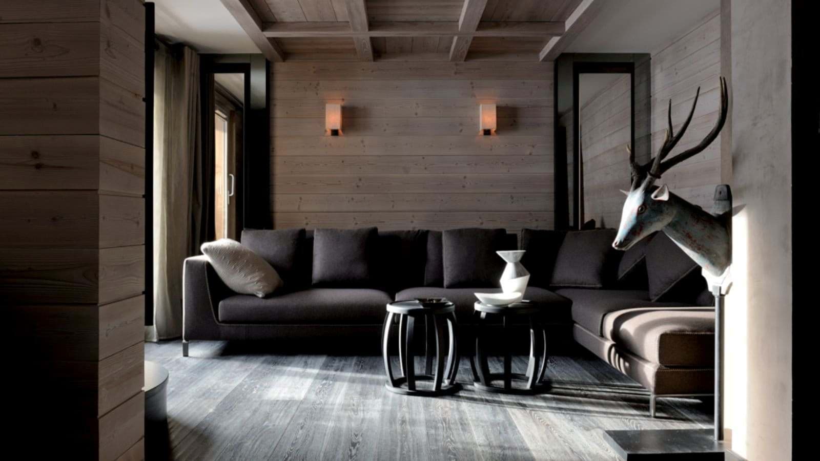 Living area with sectional seating and wood-paneled walls