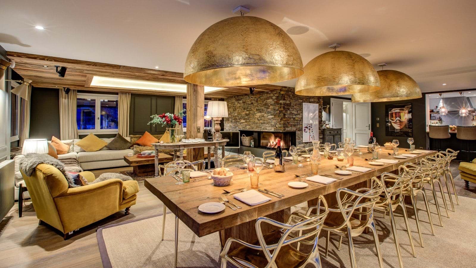 Dining table seats 12; adjacent living area with stone fireplace