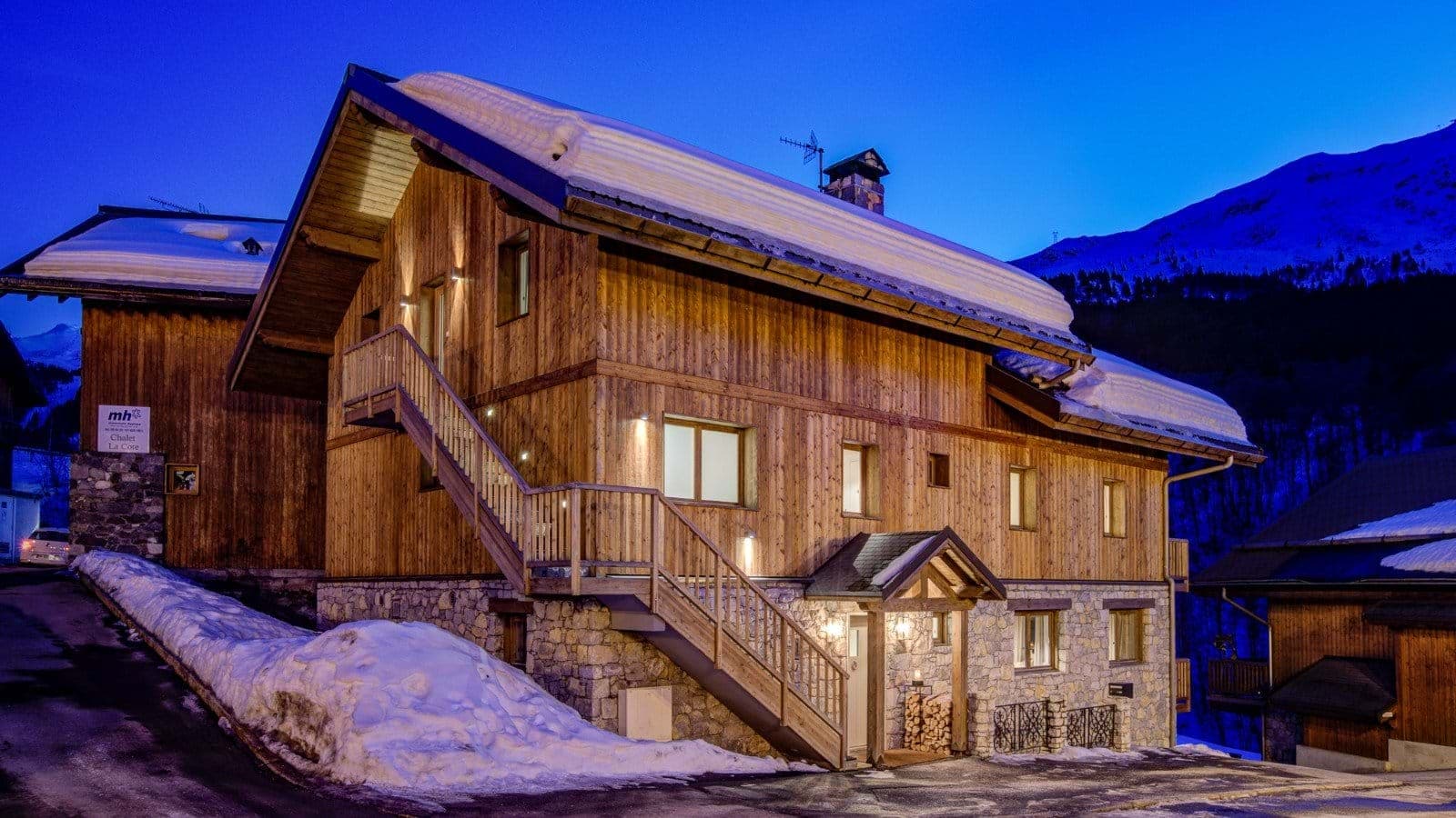 Wood and stone chalet with mountain views and external stairs