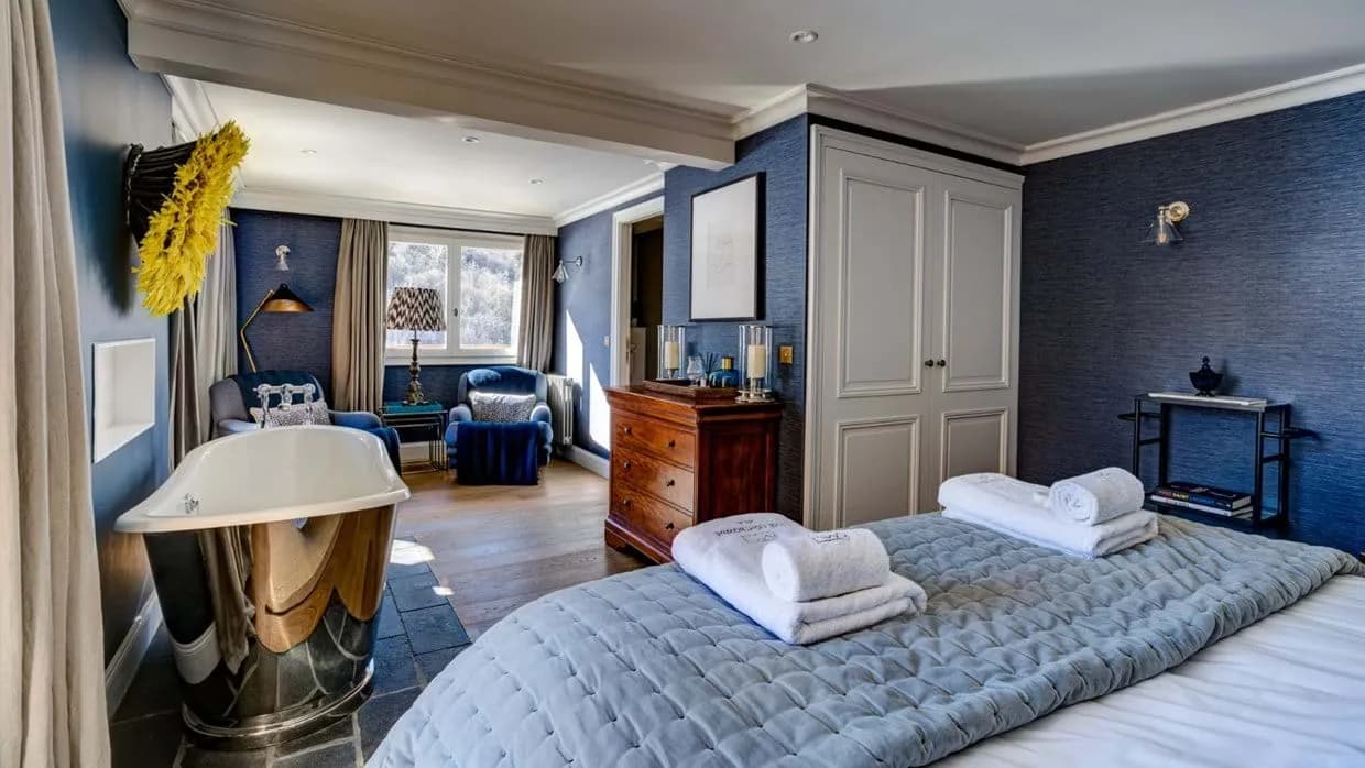 Primary bedroom with king bed and chrome soaking tub
