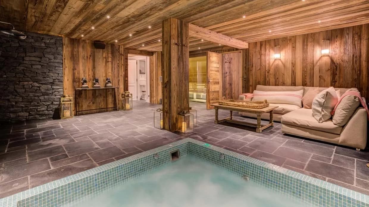 Indoor spa with jetted hot tub, sauna, and lounge seating