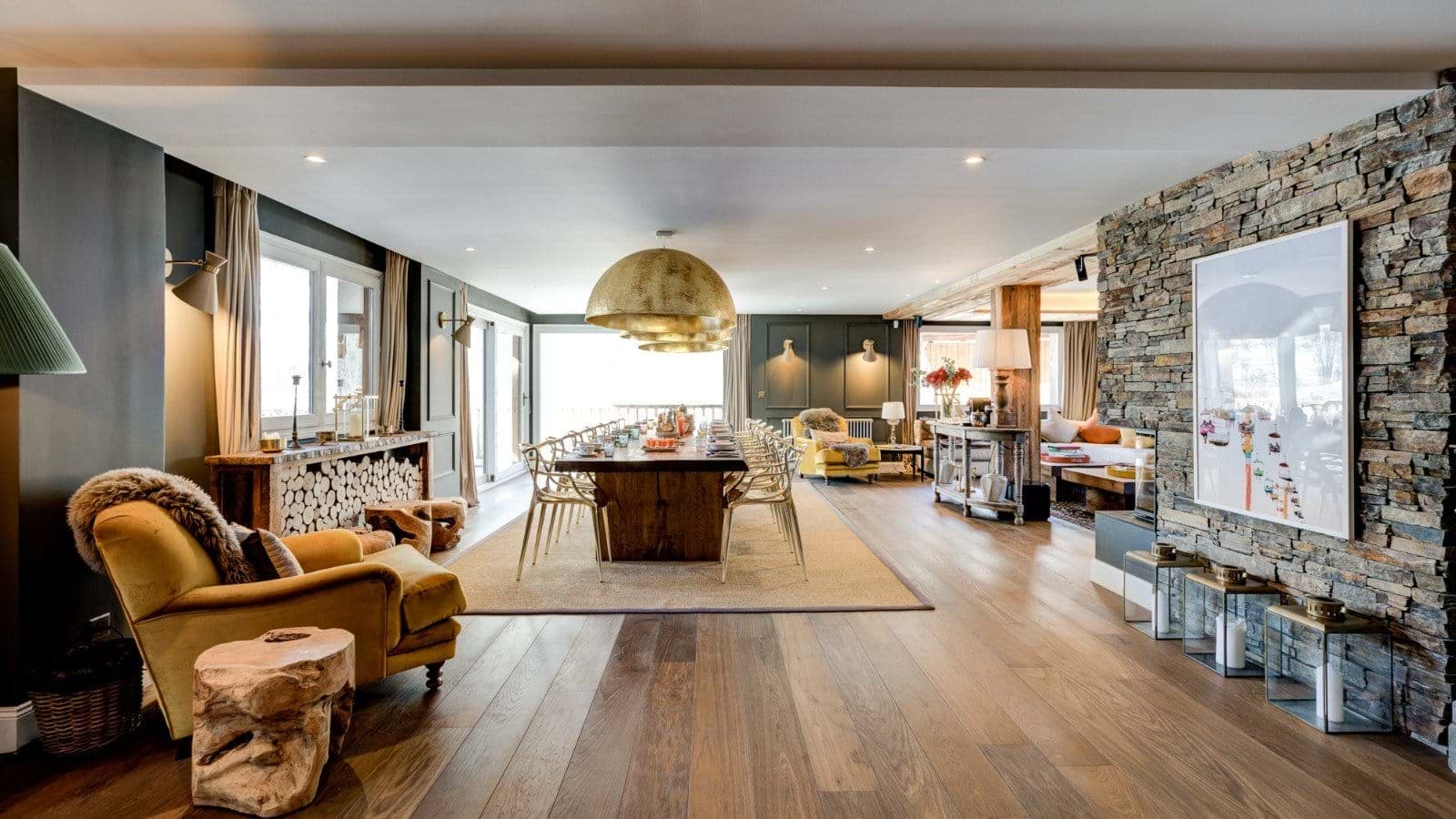 Open-plan dining area with seating for 14 and stone accent wall