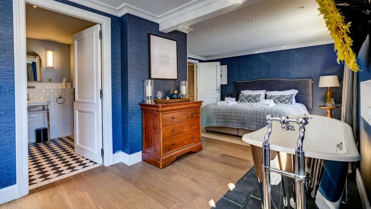 Primary suite with king bed and in-room clawfoot tub