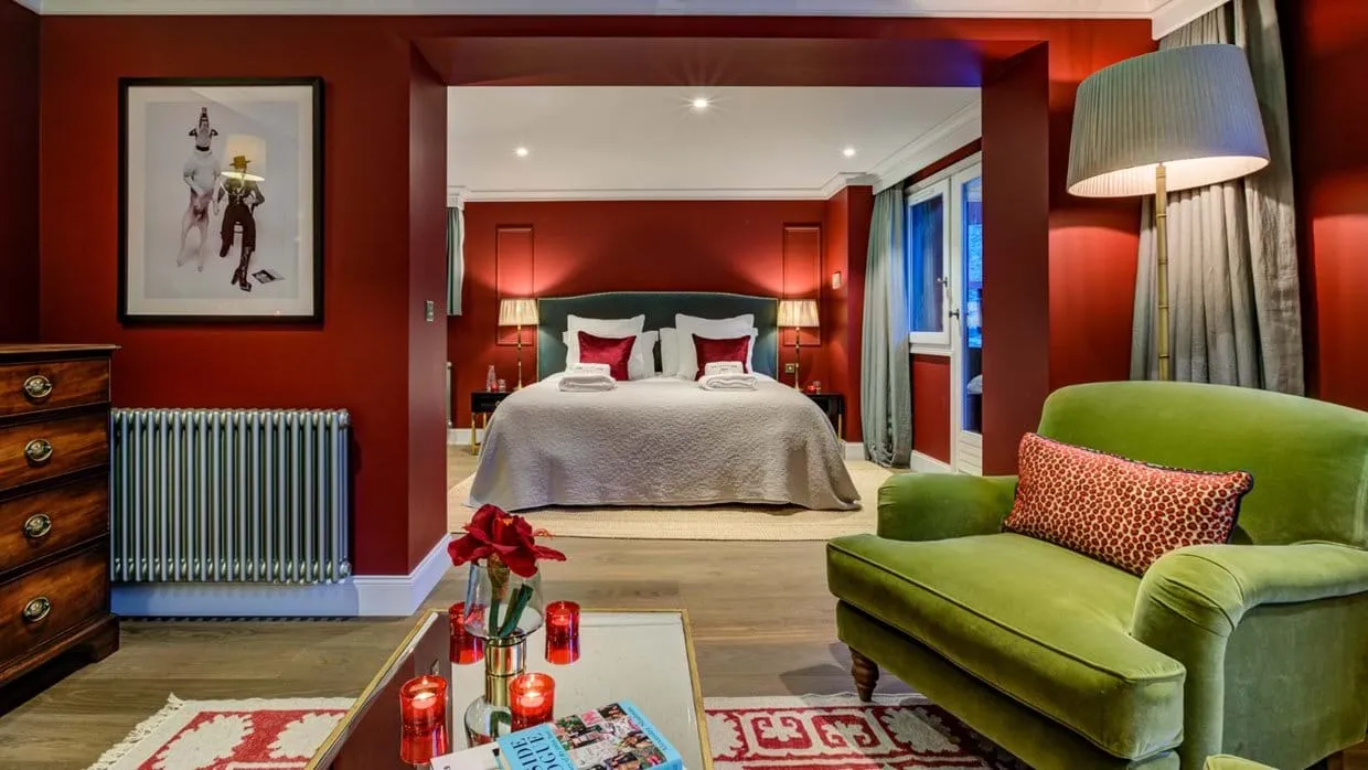 Bedroom suite with king bed and seating area; balcony access