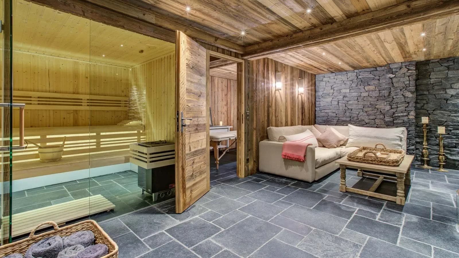 Private spa with glass-walled sauna, lounge, and adjacent massage room