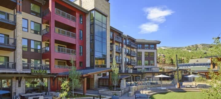 Limelight Hotel exterior with private balconies and pool terrace near ski lifts