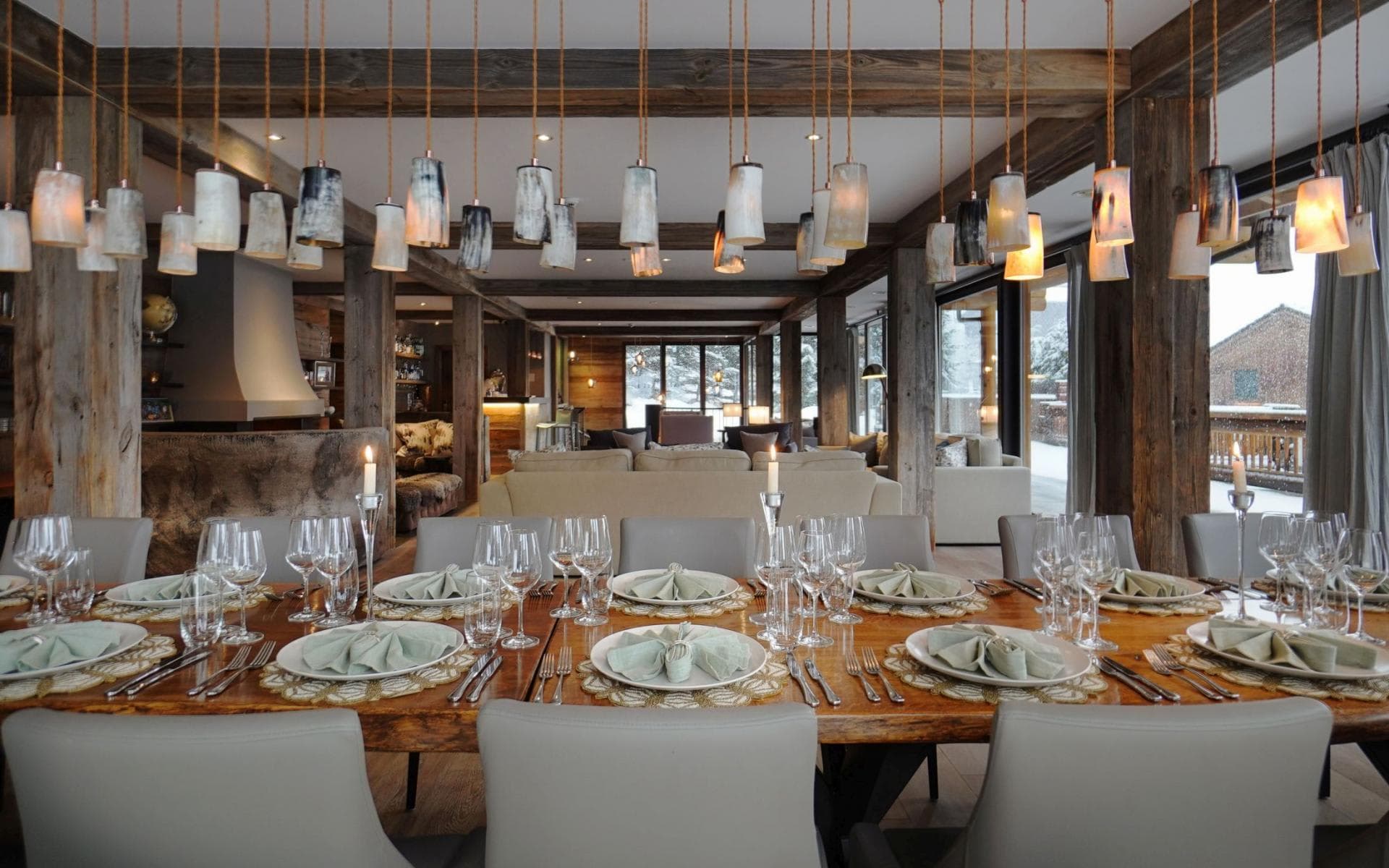 Dining table seats 10; open-plan layout with reclaimed wood beams