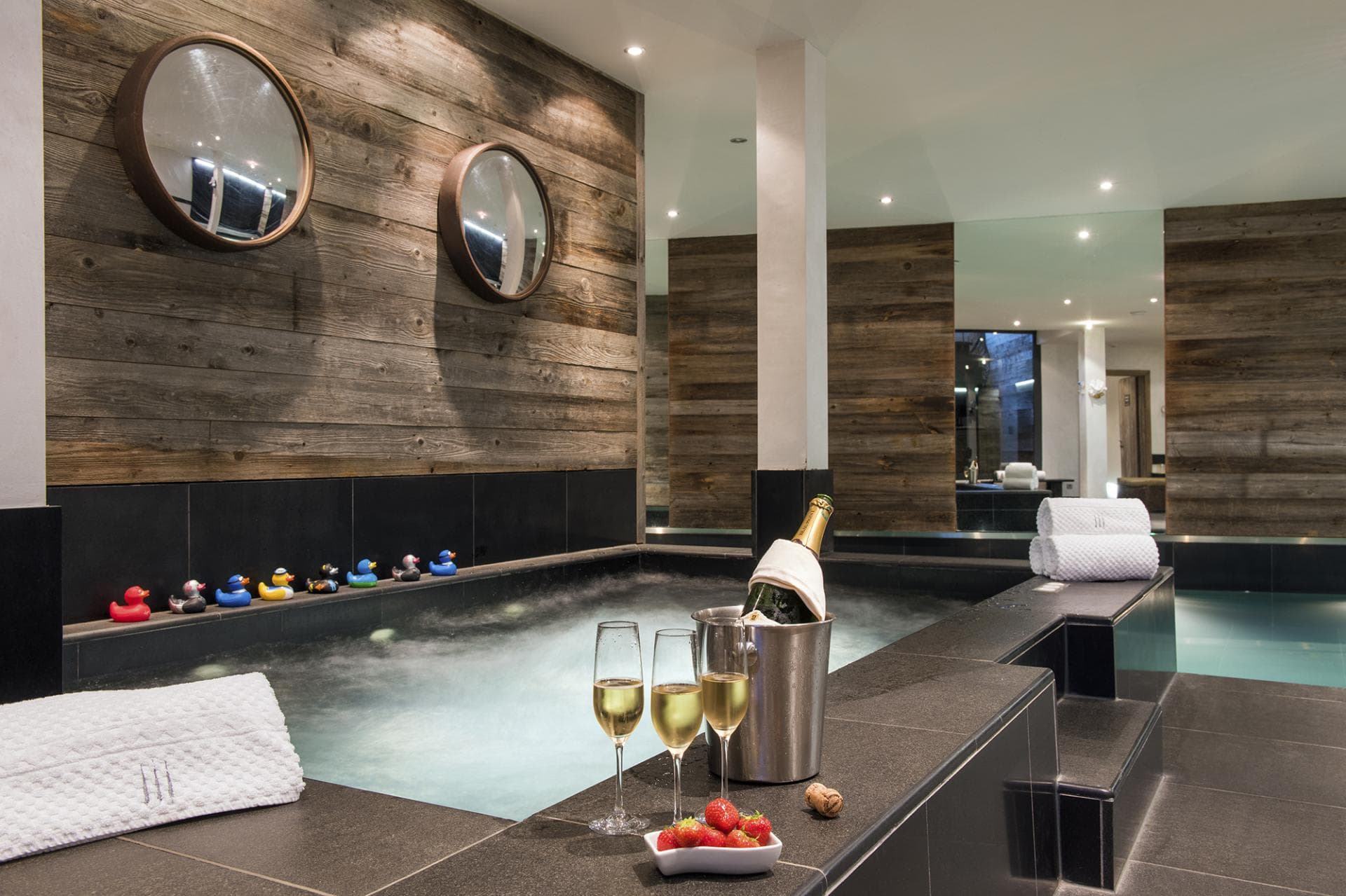 Indoor hot tub and plunge pool with reclaimed wood paneling