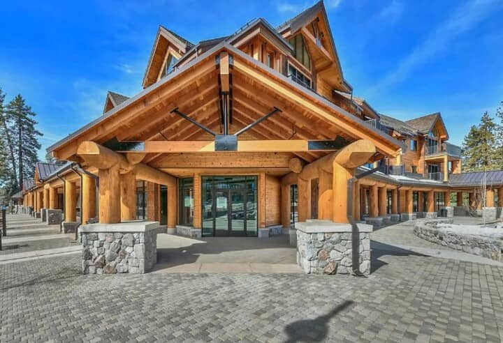 Timber-framed main entrance with covered portico and stone pillars