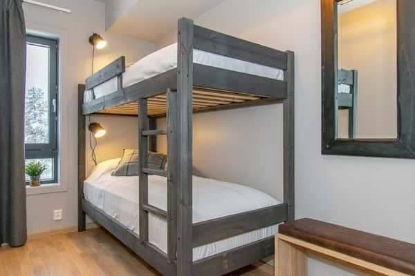 Guest bedroom with twin bunk beds and individual reading lights