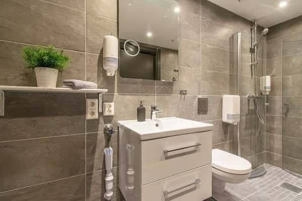 Bathroom with walk-in rainfall shower and vanity storage