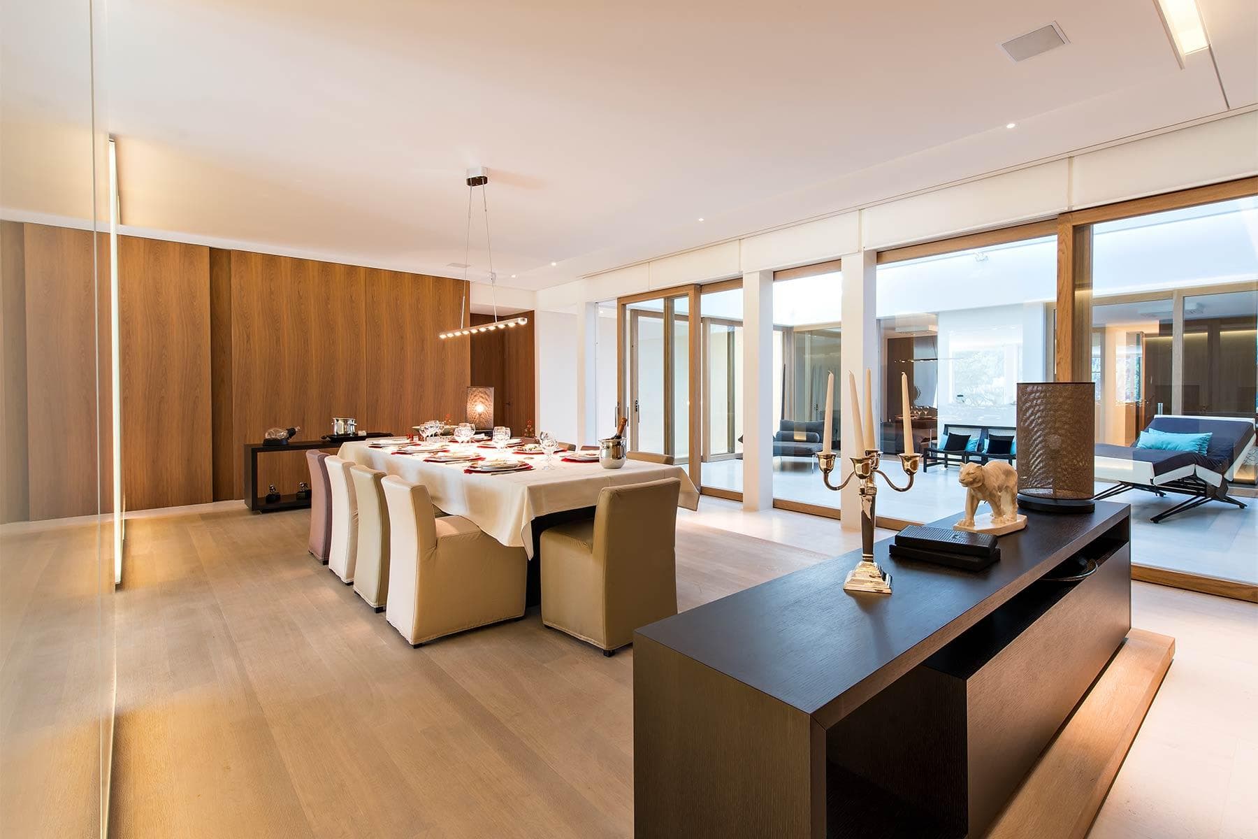 Dining area with seating for 10 and floor-to-ceiling glass doors