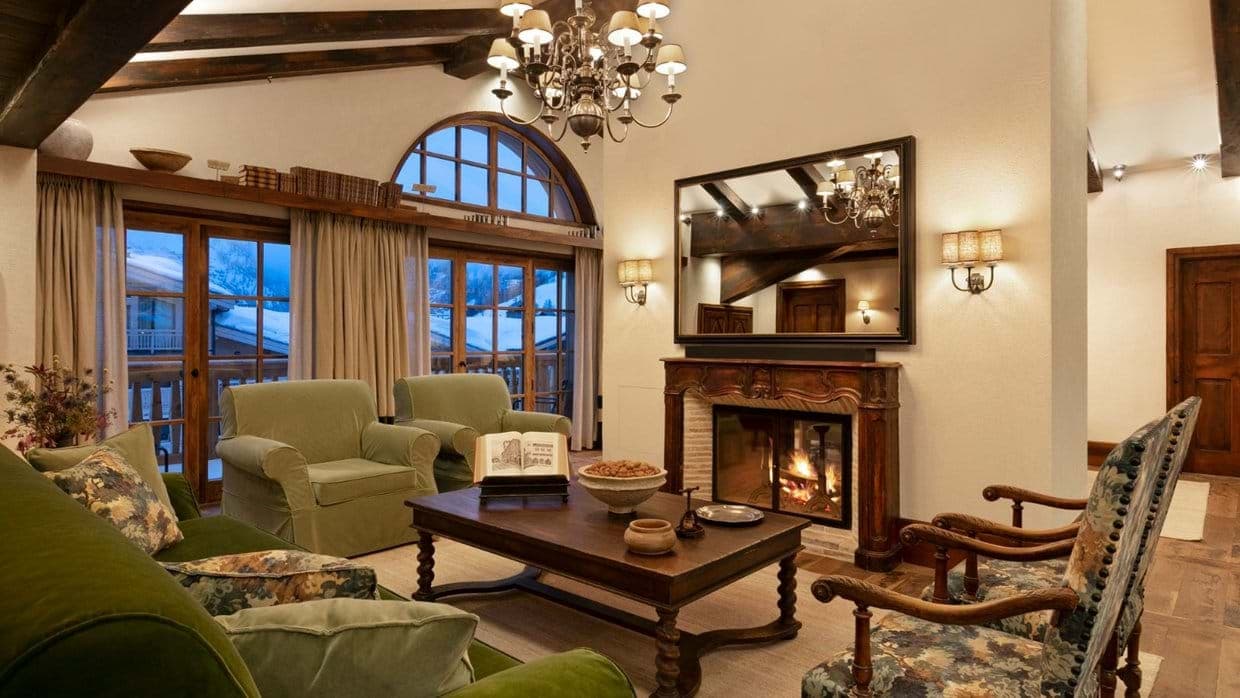 Living room with wood-burning fireplace and exposed ceiling beams