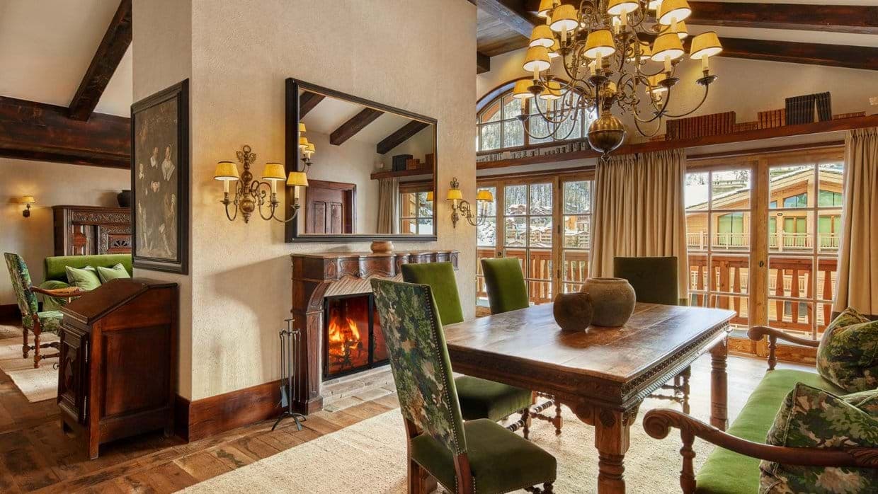 Dining room with wood-burning fireplace and balcony access