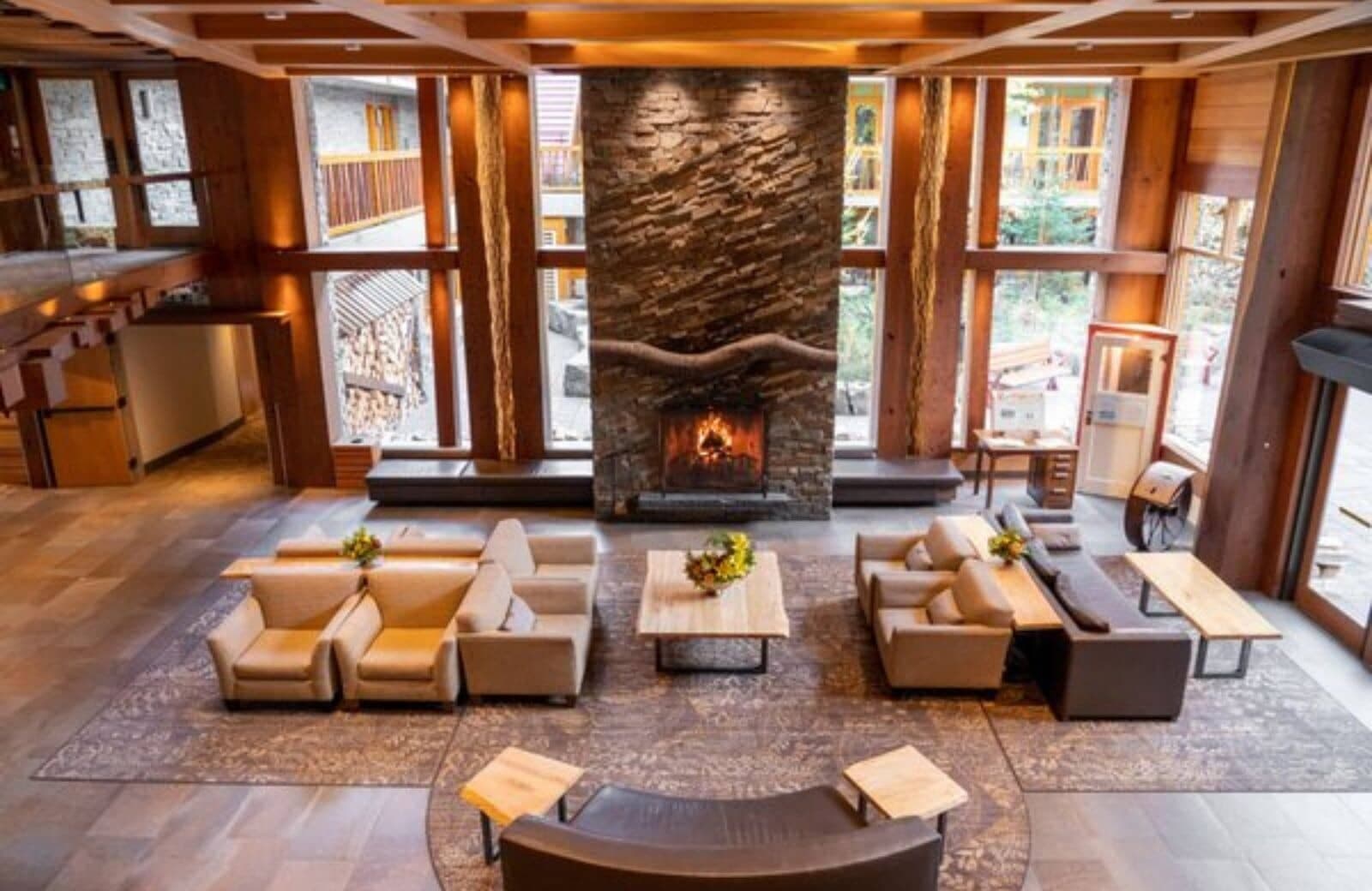 Great room with floor-to-ceiling windows and stone fireplace; seats 10