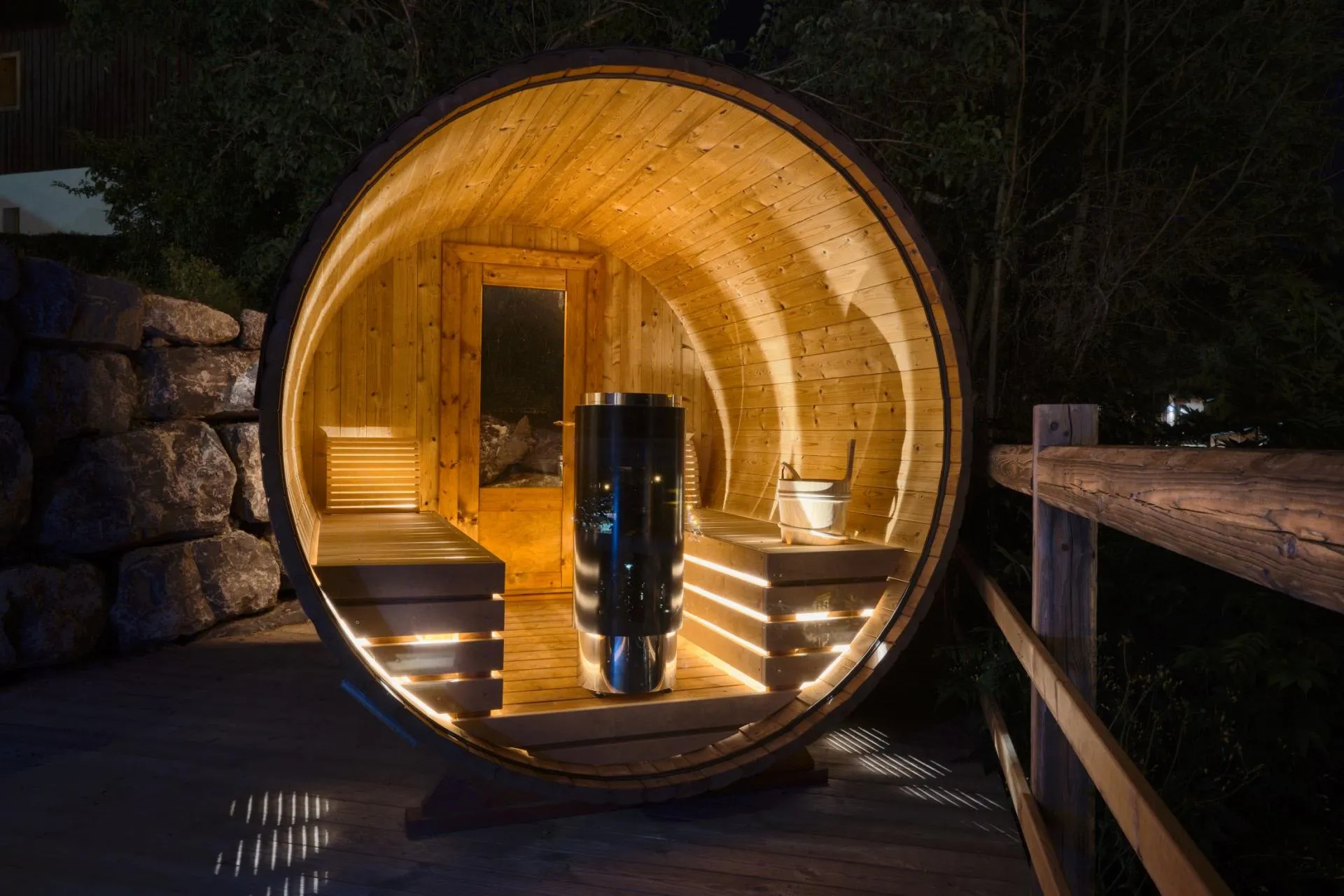 Outdoor barrel sauna with electric heater and integrated bench lighting