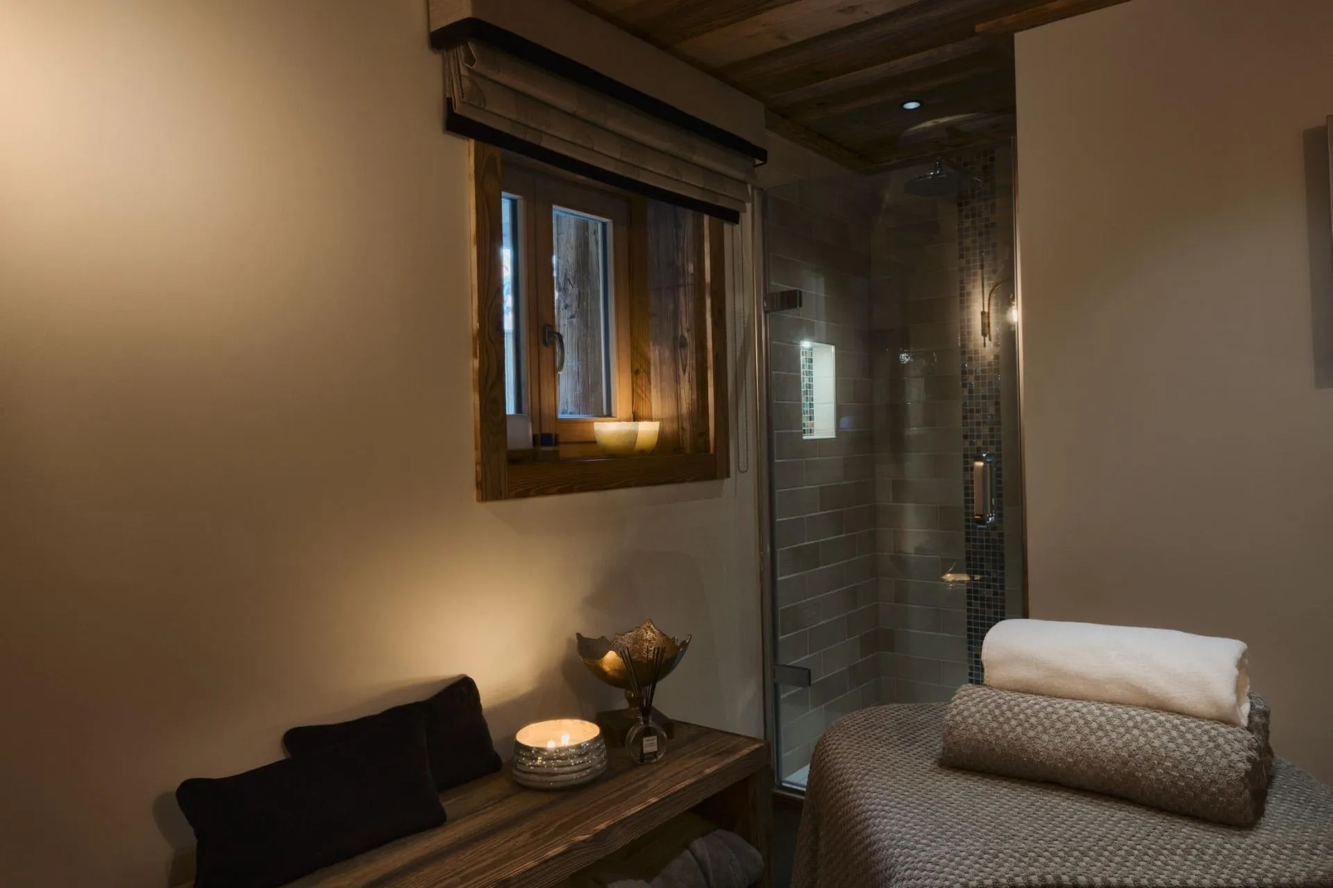 Spa room with massage table and walk-in rainfall shower