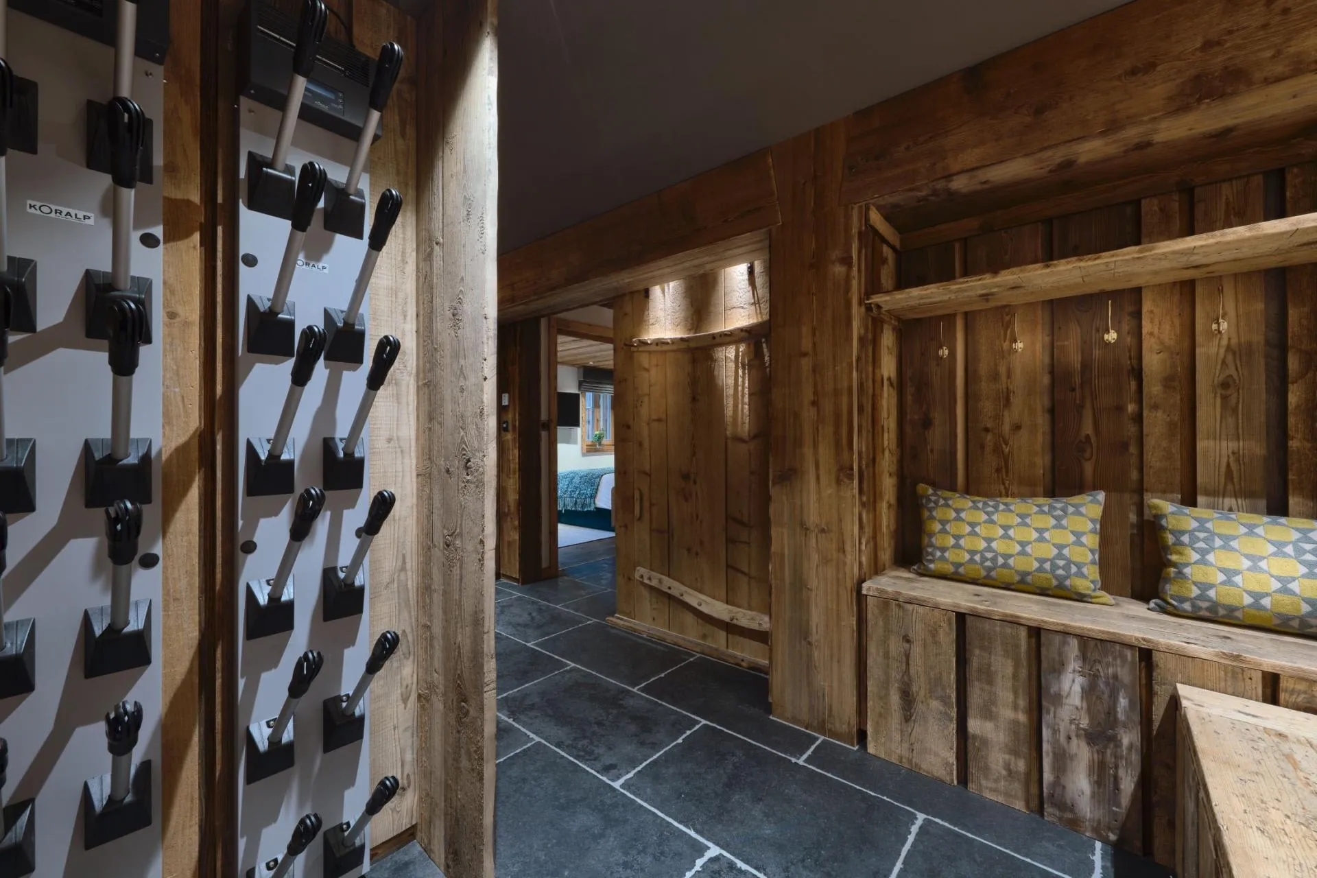 Ski room with heated boot dryers and bench seating