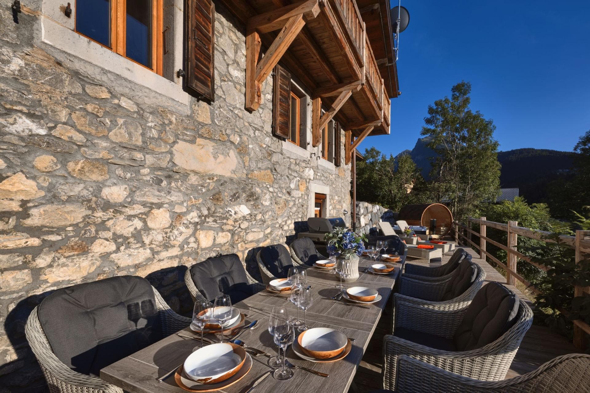 Stone terrace with dining for 10, barrel sauna, and mountain views
