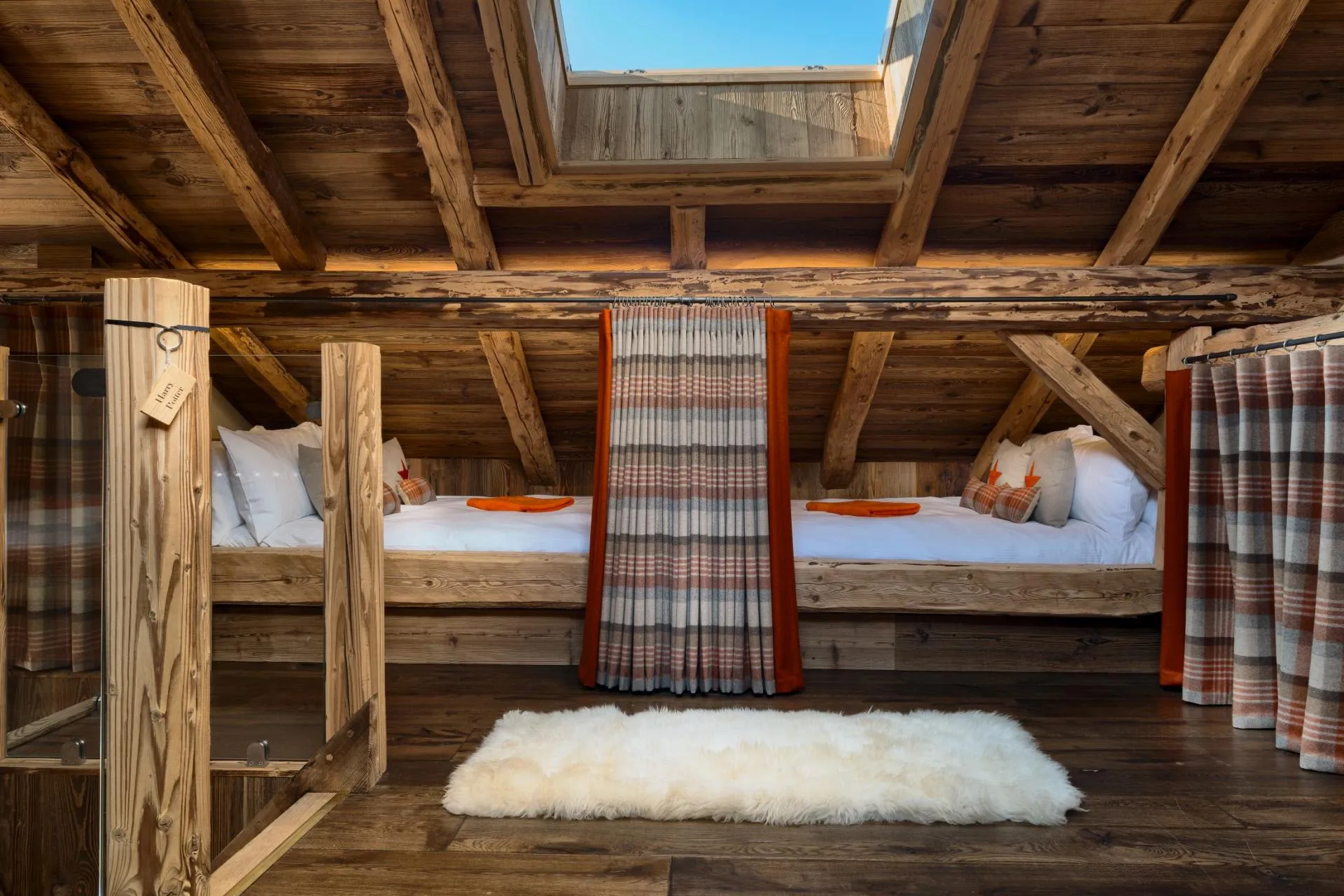 Mezzanine sleeping area with four curtained full-size double cabin beds