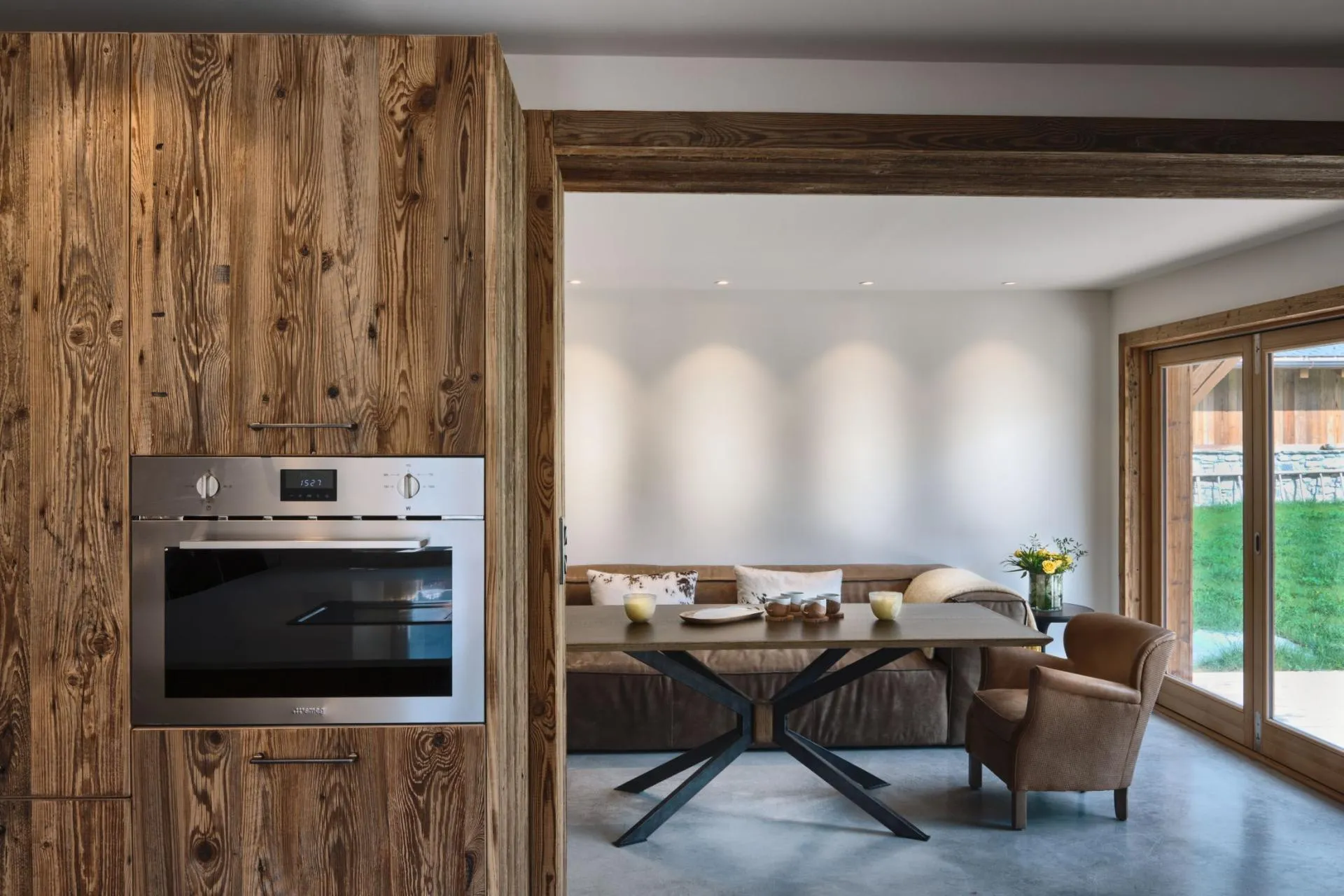 Kitchen wall oven and open-plan dining area with patio access