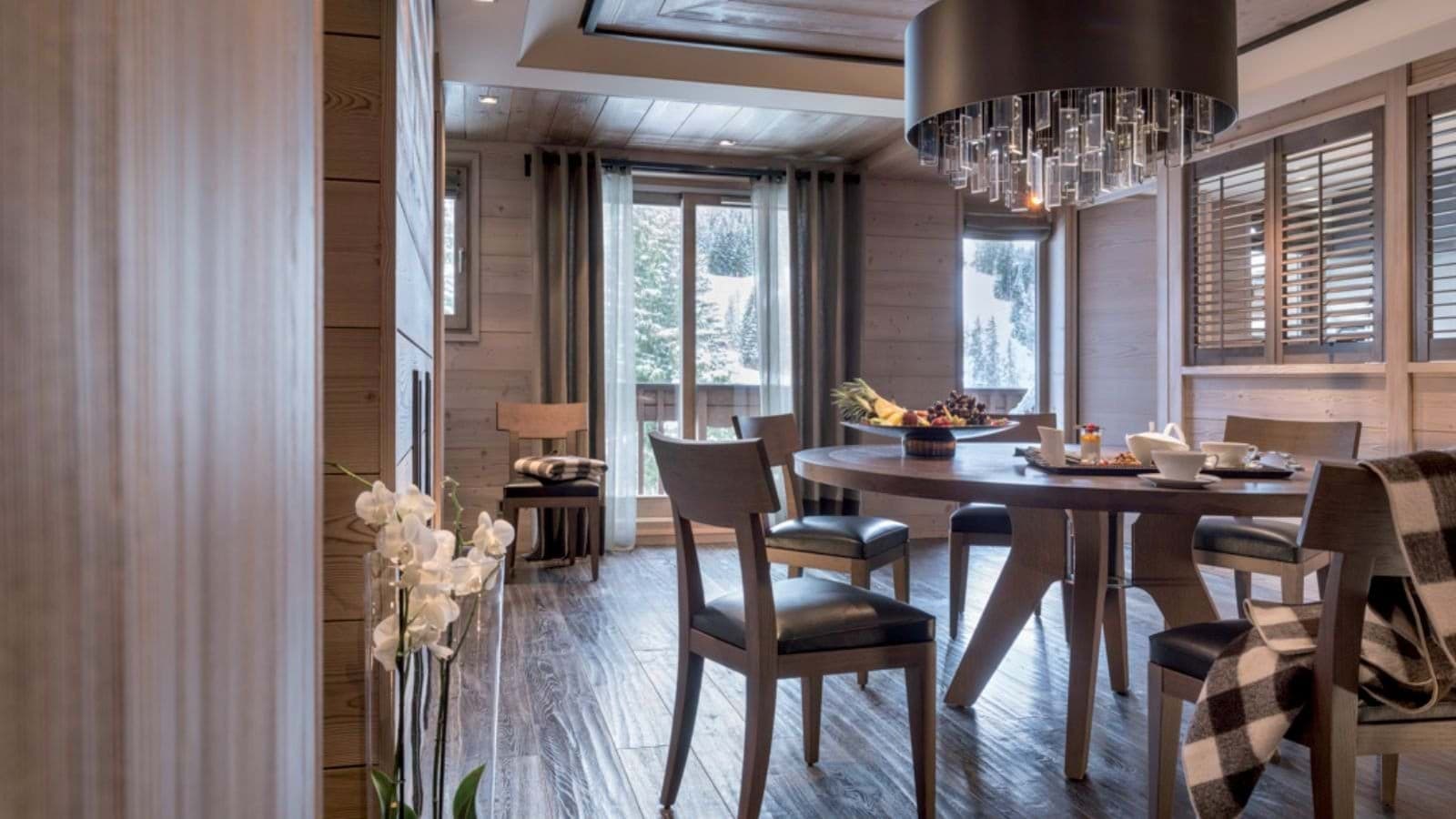 Dining area with round table and views of snowy slopes