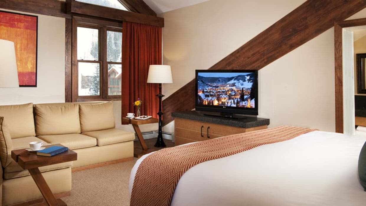 Guest suite with king bed and separate sofa seating area