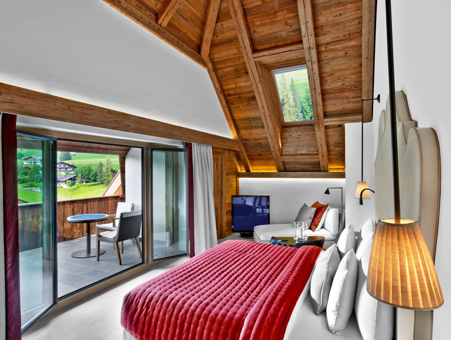 Loft bedroom with private balcony and vaulted timber ceiling