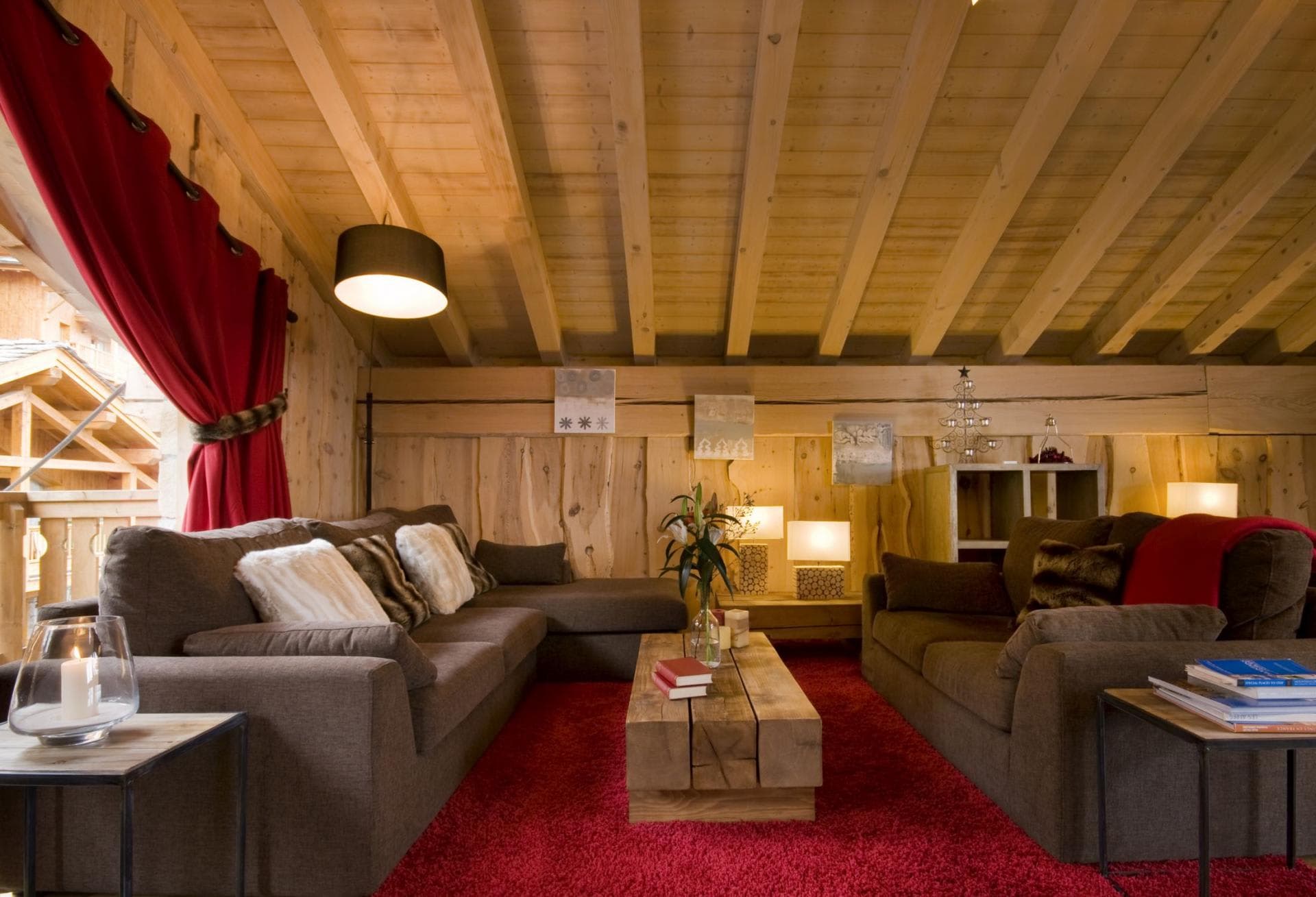 Living area with vaulted timber ceiling and balcony access