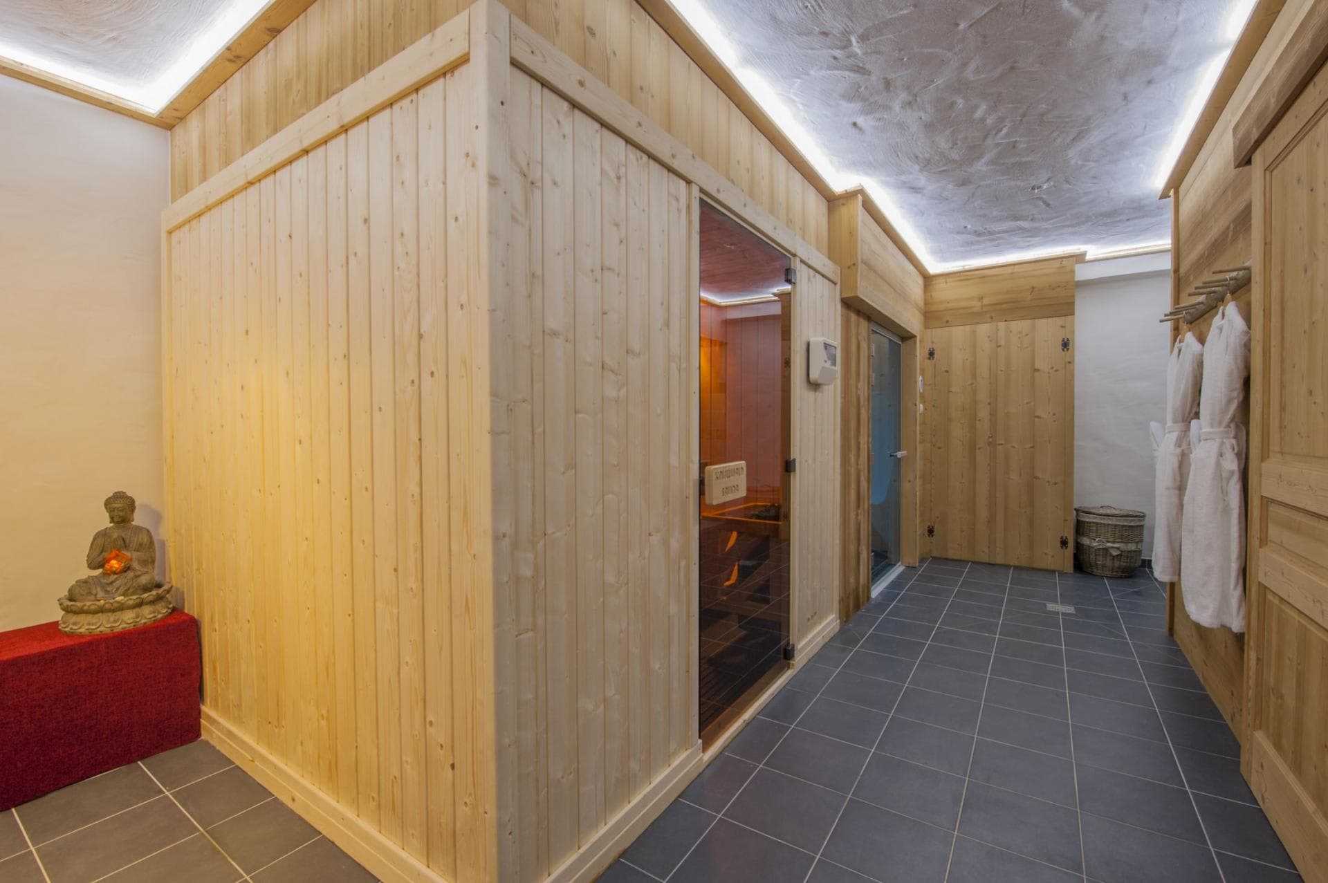 Private spa area with wood-paneled sauna and provided robes